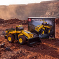 Reobrix 22009 RC wheel loader building set, yellow — built model with its box in a quarry scene