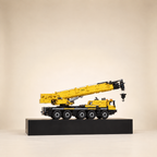 Mould King 17073 5-axle mobile crane building set, yellow — built model on display base, telescopic boom raised