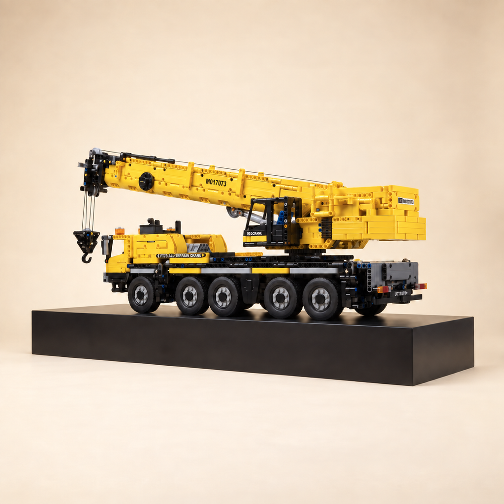 Mould King 17073 5-axle mobile crane building set, yellow — built model on display base, front three-quarter view