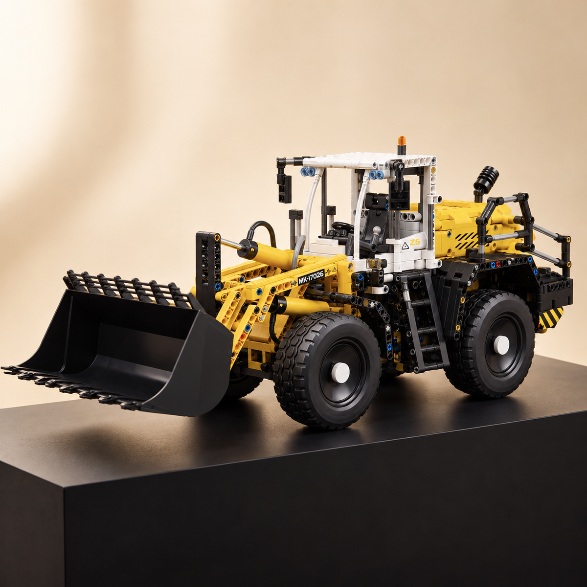 Mould King 17026 RC pneumatic wheel loader building set — built model on display base, front three-quarter view, bucket raised