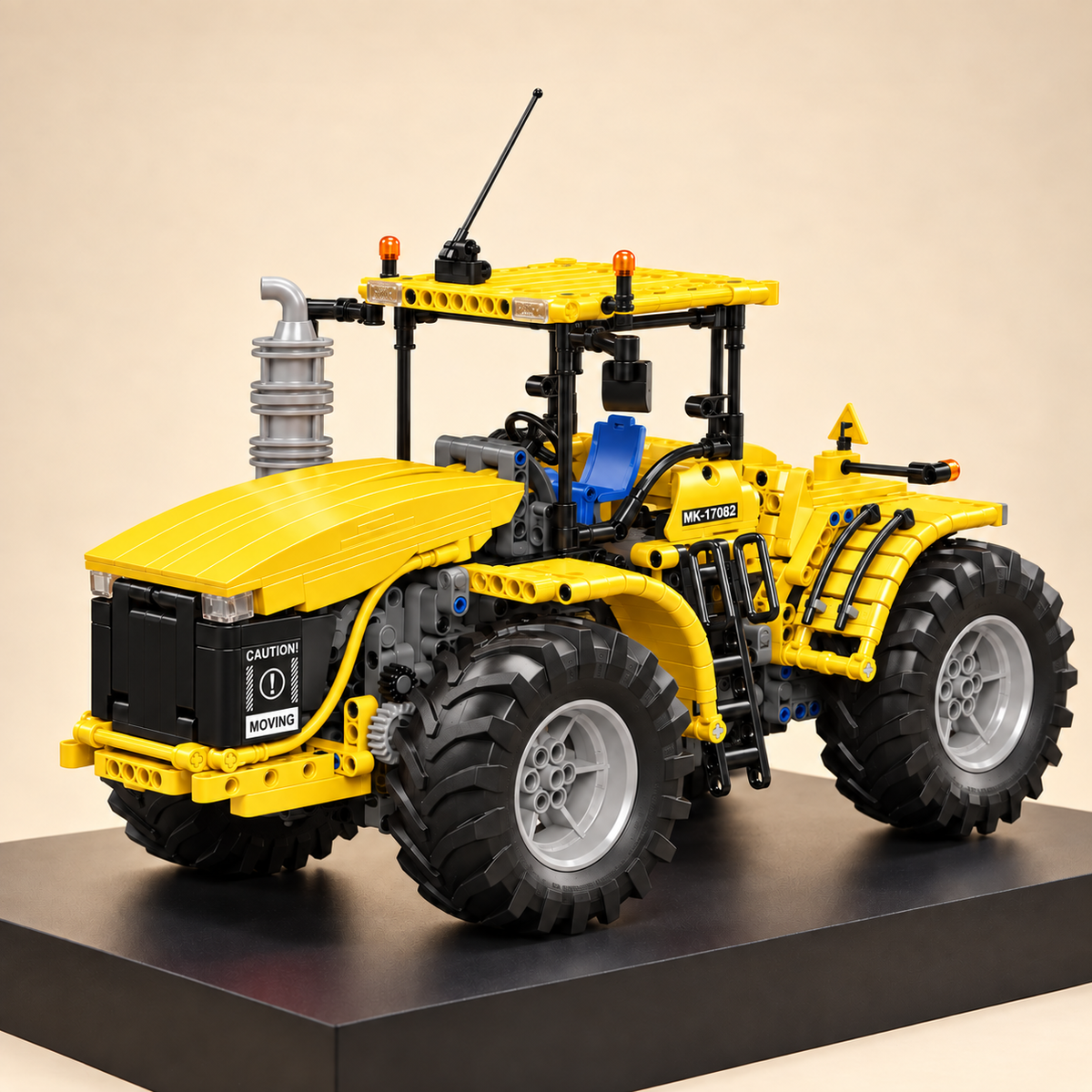Mould King 17081 articulated 4x4 tractor building set, yellow — built model on display base, front three-quarter view