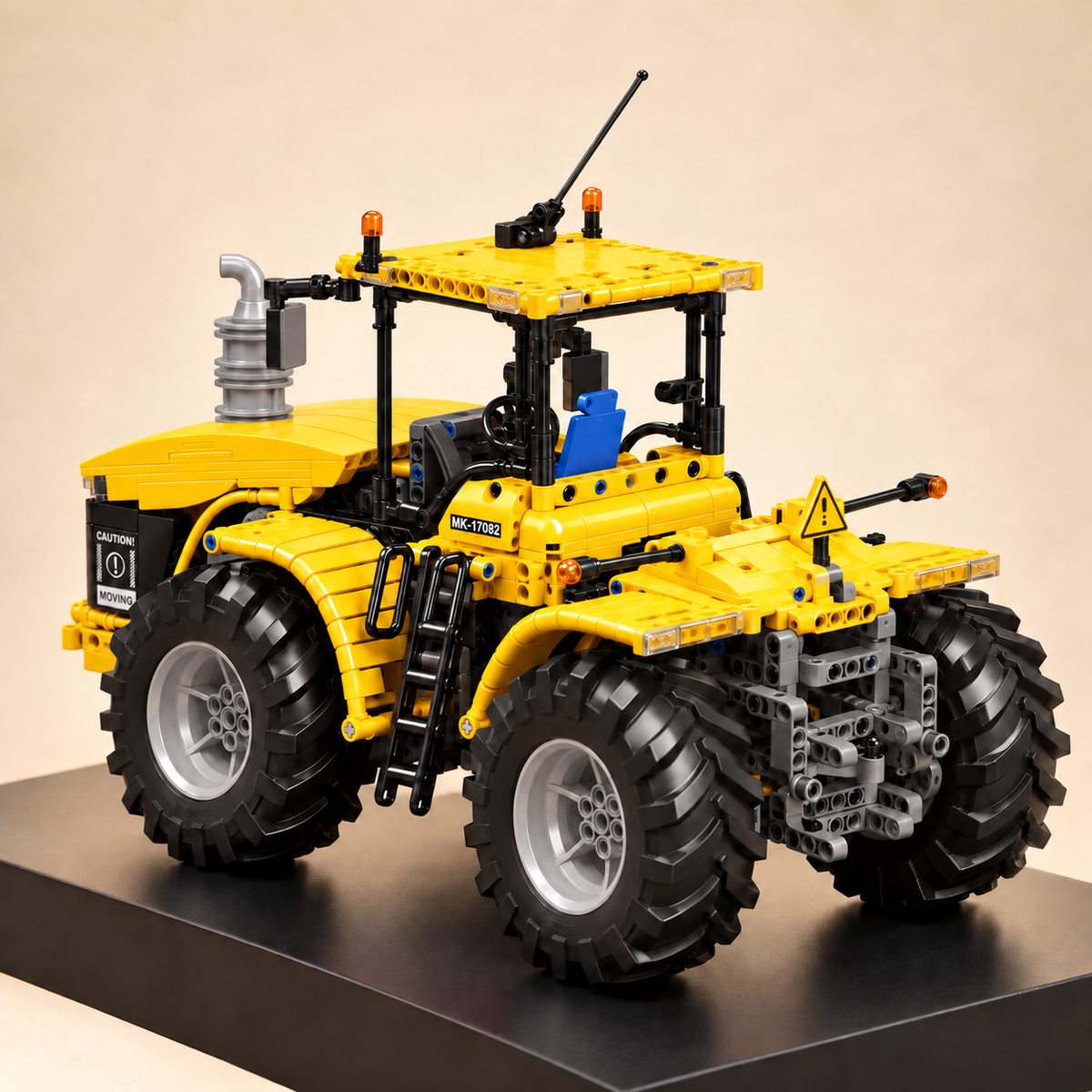 Mould King 17081 articulated 4x4 tractor building set, yellow — built model on display base, rear three-quarter view